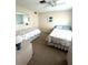 Bright bedroom with ceiling fan, two twin beds, and neutral-toned walls at 16 Nautical Dr, North Port, FL 34287