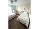 Bright bedroom with ceiling fan, two twin beds, and neutral-toned walls at 16 Nautical Dr, North Port, FL 34287