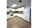 Well-lit kitchen featuring white cabinets, appliances, and tile flooring at 16 Nautical Dr, North Port, FL 34287
