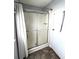 Bathroom shower with sliding glass doors and a white shower curtain at 16 Nautical Dr, North Port, FL 34287
