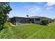 Well maintained backyard with a screened in pool and plenty of green space for activities at 1726 Claw Ct, Venice, FL 34293