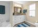 Bright bathroom featuring a granite countertop, and a decorative mirror at 1726 Claw Ct, Venice, FL 34293