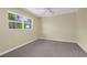 Serene bedroom with soft carpeting, neutral walls, and a sunny window, creating a cozy retreat at 1726 Claw Ct, Venice, FL 34293