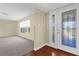 Light-filled foyer featuring decorative glass front door, light colored walls and wood flooring at 1726 Claw Ct, Venice, FL 34293
