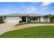 Charming single-story home featuring a well-manicured lawn, garage, and a welcoming front entrance at 1726 Claw Ct, Venice, FL 34293