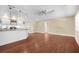 Open-concept kitchen with white cabinets, stainless appliances, and hardwood floors to a connected living area at 1726 Claw Ct, Venice, FL 34293