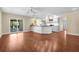 Bright, open kitchen with white cabinetry, stainless appliances, and a large island with pendant lighting at 1726 Claw Ct, Venice, FL 34293