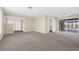 Inviting living room with carpet floors, access to screened lanai, and neutral paint at 1726 Claw Ct, Venice, FL 34293