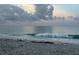 Ocean view of a wave crashing on the shore under a cloudy sky at 1726 Claw Ct, Venice, FL 34293