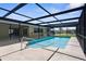Screened-in pool area showcasing a sparkling pool with patio space, perfect for outdoor relaxation at 1726 Claw Ct, Venice, FL 34293