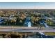 Wide aerial view of a residential area featuring homes nestled among mature trees and greenery at 177 Ingram Blvd, Rotonda West, FL 33947
