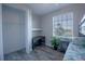 Bedroom with closet, desk, wood-look tile flooring and large sunny window at 177 Ingram Blvd, Rotonda West, FL 33947