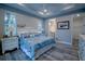A bedroom with a queen bed, coastal decor, and grey wood-look floors at 177 Ingram Blvd, Rotonda West, FL 33947
