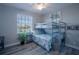 Bedroom with bunkbeds, coastal decor, wood-look tile, ceiling fan, and natural light at 177 Ingram Blvd, Rotonda West, FL 33947