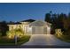 Charming one-story home with well-manicured landscaping and driveway leading to garage at 177 Ingram Blvd, Rotonda West, FL 33947