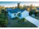 Exterior view of a blue home with a wide driveway and lush green lawn, perfect for families at 177 Ingram Blvd, Rotonda West, FL 33947