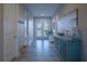 Foyer with blue cabinet, decor, and a view of the front door and entry at 177 Ingram Blvd, Rotonda West, FL 33947
