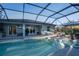 Screened pool with spa, outdoor furniture, and view of home with sliding glass doors at 177 Ingram Blvd, Rotonda West, FL 33947