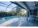 Screened-in pool with integrated spa, tile surround, and outdoor kitchen under a covered patio at 177 Ingram Blvd, Rotonda West, FL 33947