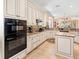 Gourmet kitchen boasts stainless steel appliances, custom cabinetry, and granite countertops at 1833 Lancashire Dr, Venice, FL 34293