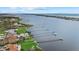 Stunning aerial view of waterfront homes with private docks along a picturesque coastline, featuring lush green lawns at 1888 Bayshore Dr, Englewood, FL 34223