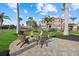 Outdoor fire pit with seating area and view of two-story home at 1888 Bayshore Dr, Englewood, FL 34223