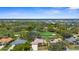 Aerial view of the property showcasing its location with a golf course, a pond, and beautiful landscaping at 1995 White Feather Ln, Nokomis, FL 34275