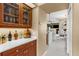 Home bar area featuring hardwood cabinets, glassware, and marble countertops at 1995 White Feather Ln, Nokomis, FL 34275