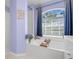 Bathroom features tub, tiled floors and shower with a blue-toned wall at 1995 White Feather Ln, Nokomis, FL 34275