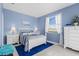 Bedroom features natural light and white furniture on top of ceramic floors and a blue rug at 1995 White Feather Ln, Nokomis, FL 34275