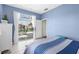 This bedroom has tile flooring with natural light and a view of the screened-in pool at 1995 White Feather Ln, Nokomis, FL 34275
