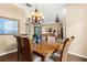 Formal dining room with a wooden table, chandelier, and view into the living area at 1995 White Feather Ln, Nokomis, FL 34275