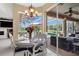 Dining room with chandelier and backyard pool view through glass doors at 1995 White Feather Ln, Nokomis, FL 34275