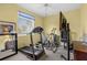 Bright home exercise room with ceiling fan and varied equipment at 1995 White Feather Ln, Nokomis, FL 34275