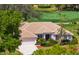 Beautiful home with a tile roof, mature landscaping, and a view of the golf course at 1995 White Feather Ln, Nokomis, FL 34275