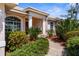 A home with lush landscaping, brick walkway, and mature trees at 1995 White Feather Ln, Nokomis, FL 34275