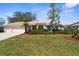 Home features lush landscaping, mature trees, and a barrel tile roof at 1995 White Feather Ln, Nokomis, FL 34275