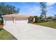 A home with a three-car garage, barrel tile roof, and concrete driveway at 1995 White Feather Ln, Nokomis, FL 34275