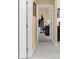Hallway leading to an exercise room with neutral walls and floors at 1995 White Feather Ln, Nokomis, FL 34275