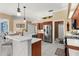 Kitchen area with breakfast bar, stainless steel appliances, and white countertops at 1995 White Feather Ln, Nokomis, FL 34275