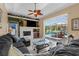 Comfortable living room with tiled fireplace and backyard pool access at 1995 White Feather Ln, Nokomis, FL 34275