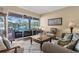 Elegant living room featuring a view of the lanai and pool, plus stylish furnishings at 1995 White Feather Ln, Nokomis, FL 34275