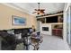 Cozy living room with fireplace, ceiling fan, and tiled floors at 1995 White Feather Ln, Nokomis, FL 34275
