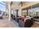 Inviting screened-in patio with stylish wicker furniture, ceiling fan, and access to outdoor living spaces at 1995 White Feather Ln, Nokomis, FL 34275