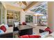 Inviting screened-in patio with comfortable seating, ceiling fan, and views of the pool and backyard at 1995 White Feather Ln, Nokomis, FL 34275