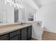 Bathroom featuring vanity with gray cabinets, large mirror and a soaking tub at 2038 Mincey Ter, North Port, FL 34286