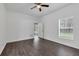 Spacious bedroom with ceiling fan, wood flooring, and a door leading to the outside at 2038 Mincey Ter, North Port, FL 34286