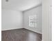 Bright bedroom featuring wood flooring, a large window and a neutral color scheme at 2038 Mincey Ter, North Port, FL 34286