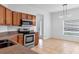 Kitchen with stainless steel appliances, wood cabinets and a breakfast area near a window at 2038 Mincey Ter, North Port, FL 34286