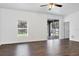 Contemporary living space with modern flooring, large windows, and a door to the backyard at 2038 Mincey Ter, North Port, FL 34286